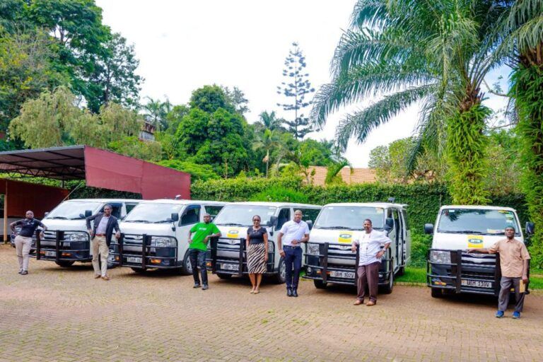 Some of the Simba Telecoms staff standing near the distributions van